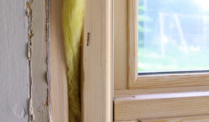 Exposed insulation between wall and window