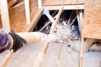 Contractor applying blown-in insulation