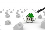 Magnifying glass pointing at house