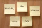 Post-it notes listing home utilities such as gas and cable