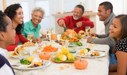 Family sitting at a table eating turkey