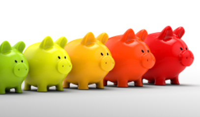 row of multi-colored piggy banks from small to large in size.