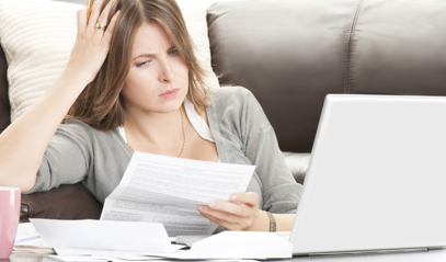 young woman looking at a bill